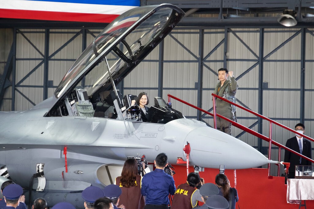 Taiwan's President Tsai Ing-wen poses for photos from the cockpit during a ceremony to commission into service 64 upgraded F-16V fighter jets at a...