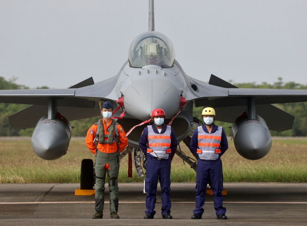 Pilot and navy officers pose in front of a F-16V fighter at the commission of the first squadron of the upgraded F-16V fighters in Chiayi Air Force Ba...