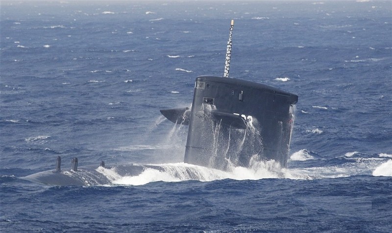 Spindrift dissipates into the air as Taiwan's current Hai Lung diesel-electric submarine surfaces from beneath the waves. 
