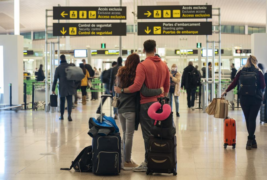A couple stand outside the security control section inside a terminal of the Barcelona Airport, Wednesday, Dec. 1, 2021. Health authorities in the Spa...