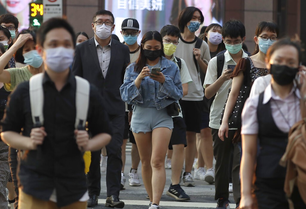 People wear face masks to help protect against the spread of the coronavirus in Taipei, Taiwan, Thursday, Sept. 30, 2021. 
