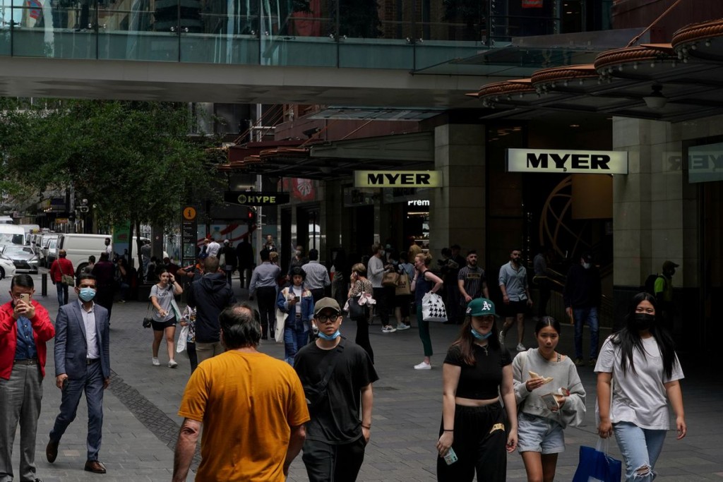 Pedestrians walk through a shopping plaza in the city centre, as the state of New South Wales surpasses the 90 percent double-dose coronavirus disease...