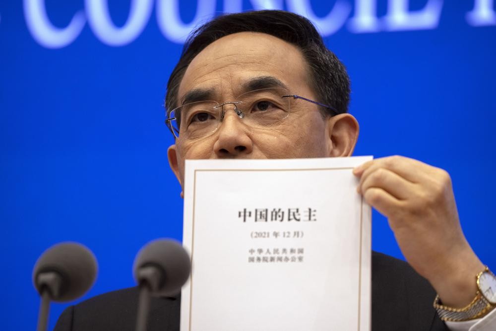 Xu Lin, vice minister of the Publicity Department of the Central Committee of China's Communist Party holds a copy of a government-produced report...