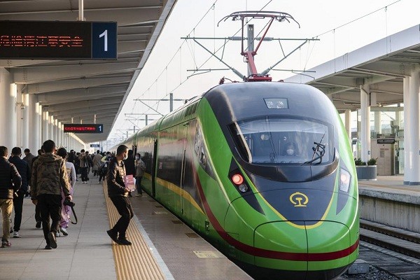 In this photo released by Xinhua News Agency, an electric multiple unit (EMU) train of the China-Laos Railway arrives at Yuxi Railway Station in Yuxi ...