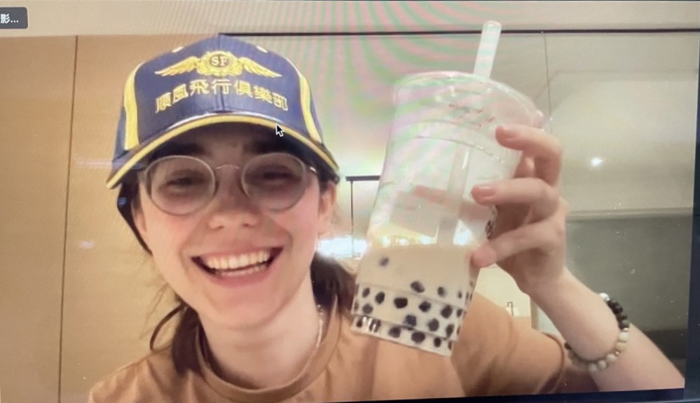 Zara Rutherford holding up bubble tea drink. 
