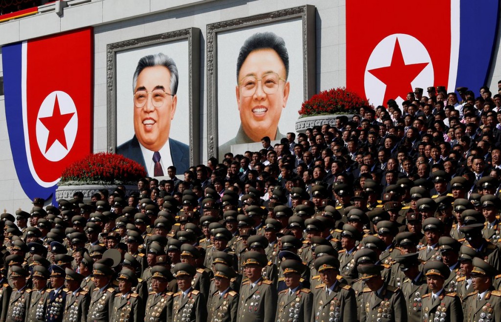 Senior military officials watch a parade as portraits of late North Korean leaders Kim Il Sung and Kim Jong Il are seen in the background at the main ...