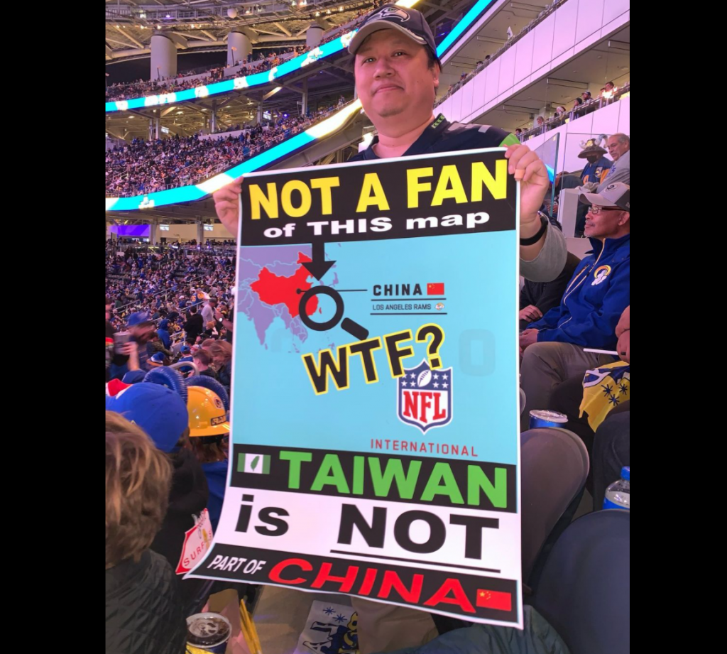 Ken Wu holds a poster protesting the NFL map showing Taiwan as part of China at a LA Rams game. (Instagram, Ken Wu photo)
