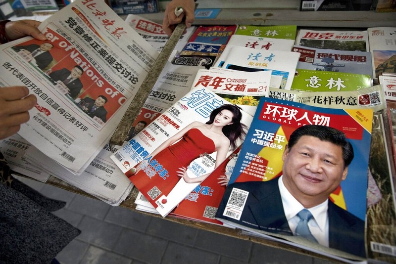 A magazine featuring Chinese President Xi Jinping is placed next to a magazine with Chinese actress Fan Bingbing at a news stand in Beijing, Oct....