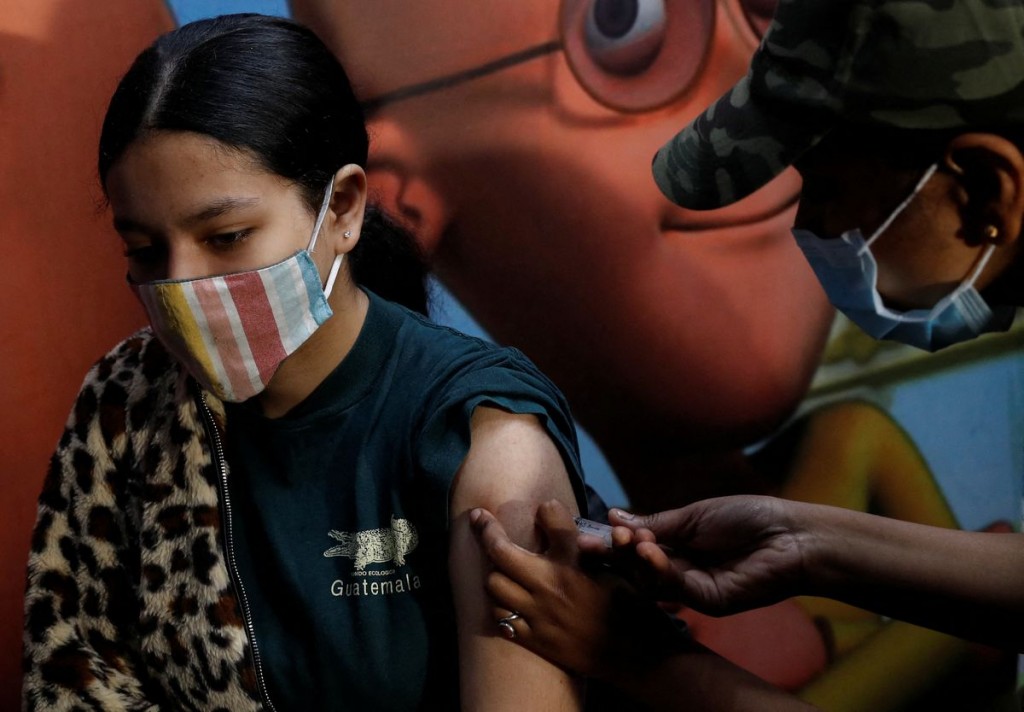 A girl receives a dose of the COVAXIN coronavirus disease (COVID-19) vaccine manufactured by Bharat Biotech, during a vaccination drive for children a...