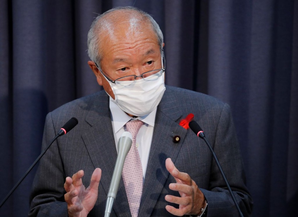Japan's new Finance Minister Shunichi Suzuki wearing a protective mask, amid the coronavirus disease (COVID-19) outbreak, speaks at a news confere...