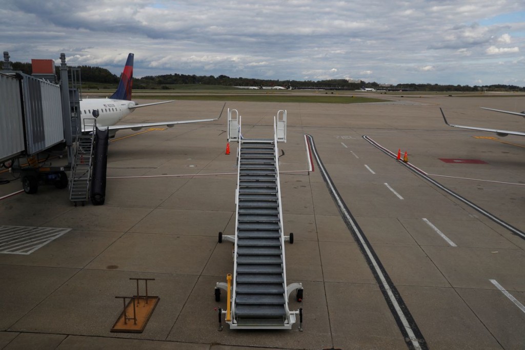 Stairs stand on a tarmac next to a Delta Air Lines plane at Pittsburgh International Airport in Pittsburgh, Pennsylvania, U.S., October 3, 2020. REUTE...