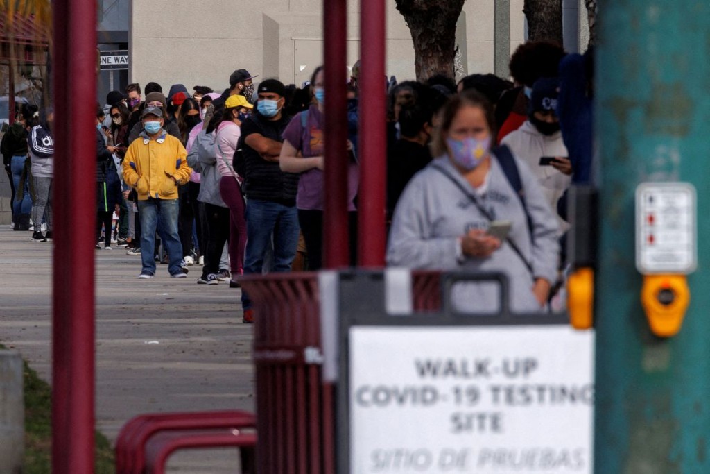 People wait outside a community center as long lines continue for individuals trying to be tested for COVID-19 during the outbreak of the coronavirus ...