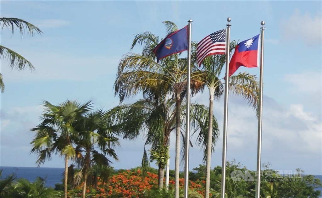 Guam, U.S., Taiwan flags. 
