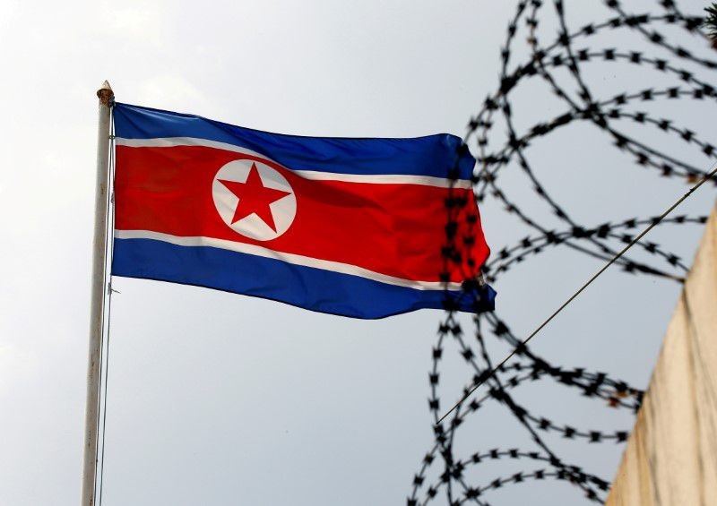 A North Korea flag flutters next to concertina wire. REUTERS/Edgar Su

