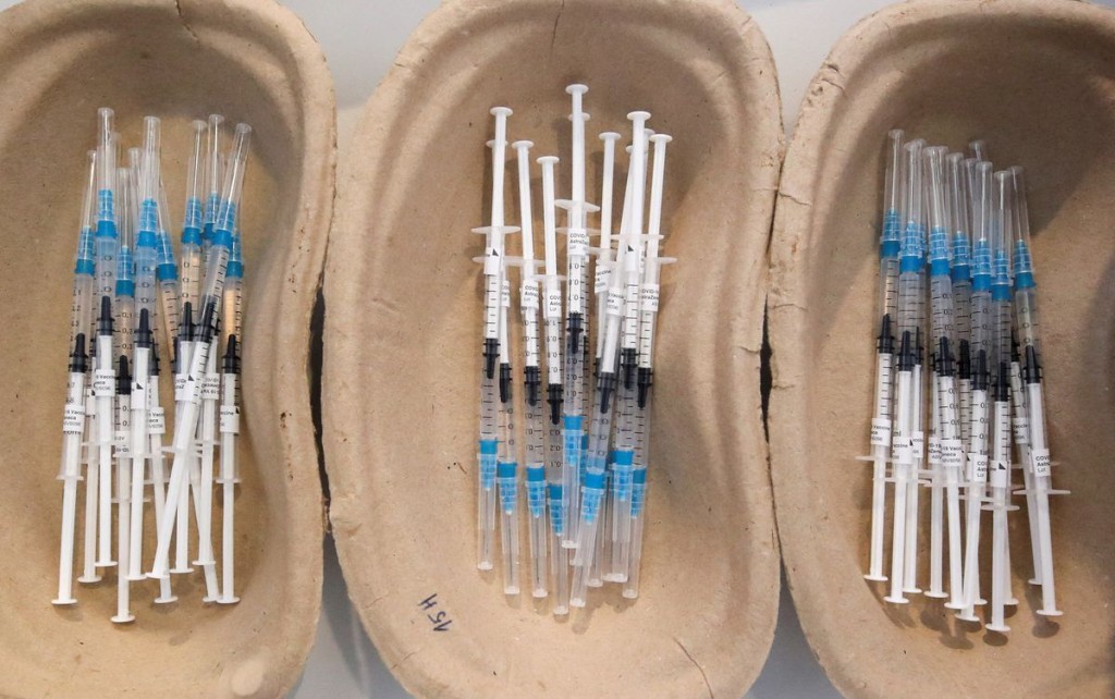 Syringes filled with Oxford/AstraZeneca's COVID-19 vaccine are pictured at a vaccination centre in Bierset, Belgium March 17, 2021. REUTERS/Yves H...