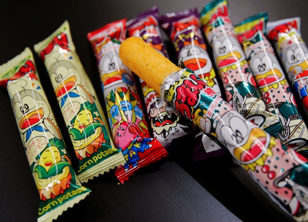 Several flavours of 'Umaibo', a popular Japanese corn snack, are displayed at a confectionery wholesaler's in Tokyo, Japan January 25, 202...
