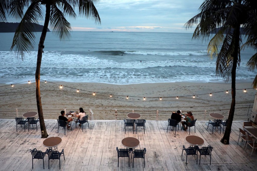 People dine-in at a restaurant following social distancing measures, as Langkawi gets ready to open to domestic tourists from September 16, amid the c...