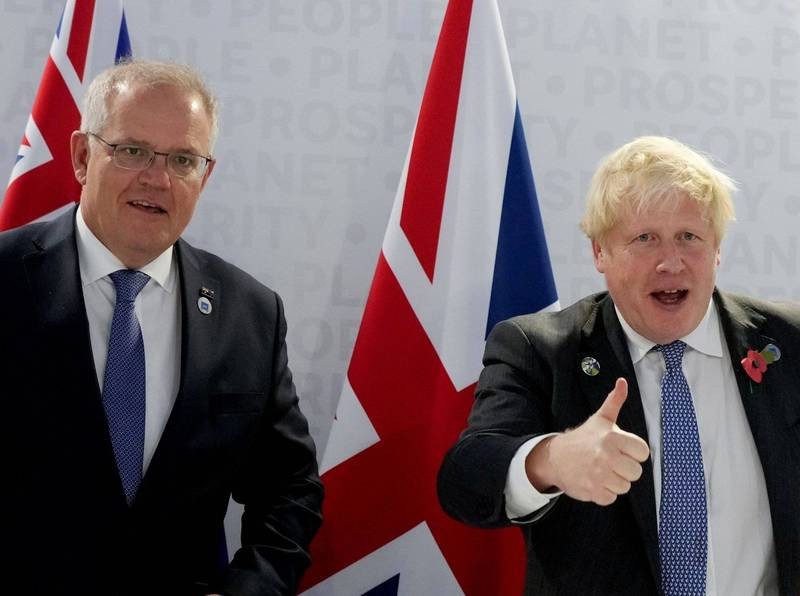  Australian Prime Minister Scott Morrison stands alongside British Prime Minister Boris Johnson as he gives a big thumbs up to the cameras. (Reut...