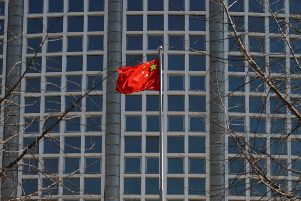 A Chinese flag flutters outside the Chinese foreign ministry in Beijing, China February 24, 2022. REUTERS/Carlos Garcia Rawlins
