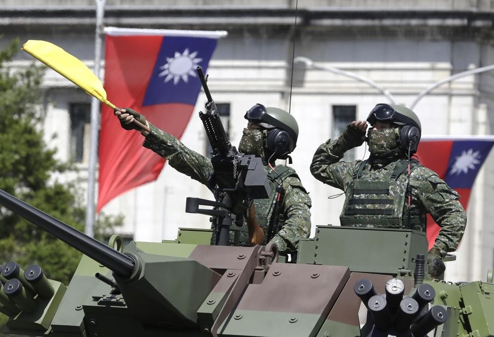 Taiwanese soldiers salute during National Day celebrations in front of the Presidential Building in Taipei, Taiwan on Oct. 10, 2021. As Russia presses...