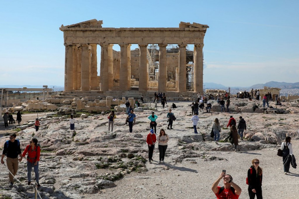 People visit the ancient Parthenon Temple atop the Acropolis hill archaeological site in Athens, Greece, February 26, 2022. Picture taken February 26,...