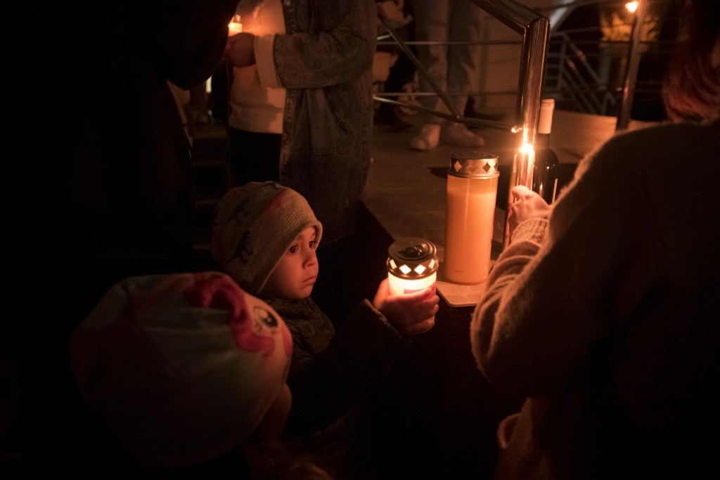 A child holds a candle during the Orthodox Easter religious service at the Brancusi Parish Church in Bucharest, Romania, Sunday, April 24, 2022. (AP p...