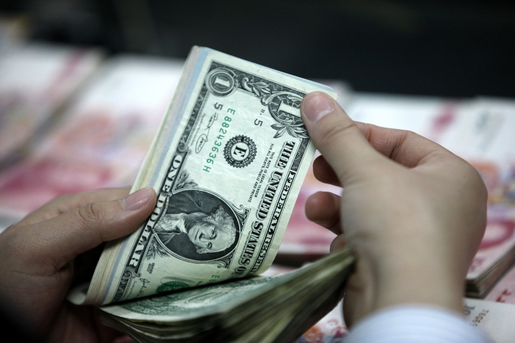 U.S. dollars and Chinese yuan. (Reuters photo)
