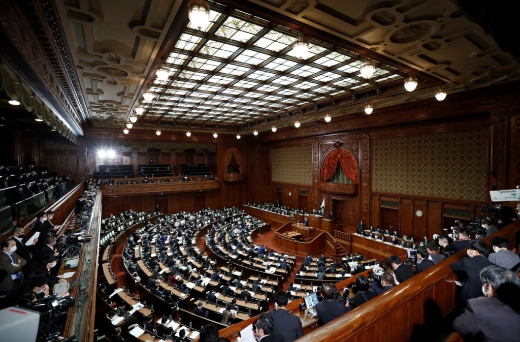 Empty seats are seen as lawmakers practice social distancing, during Japan's Prime Minister Yoshihide Suga's policy speech at the opening of t...