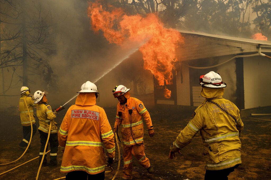 FILE - Firefighters battle the Morton Fire as it burns a home near Bundanoon, Australia on Jan. 23, 2020. 
