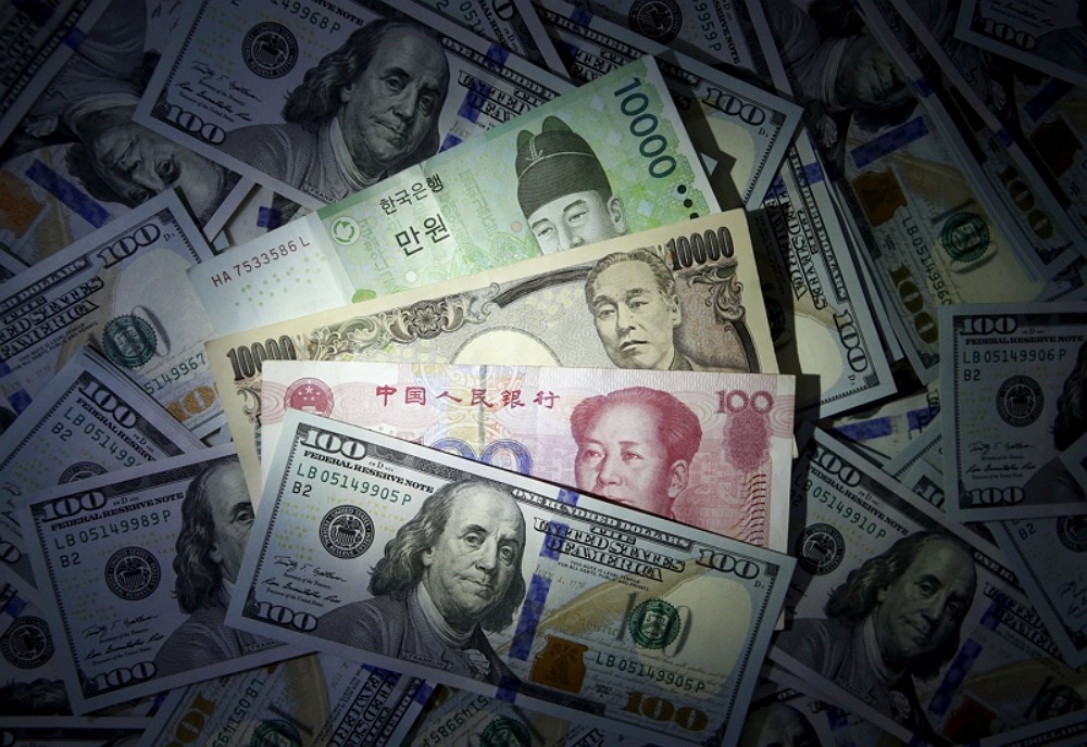 South Korean won, Chinese yuan and Japanese yen notes are seen on U.S. 100 dollar notes in this file photo illustration shot December 15, 2015. (Reute...