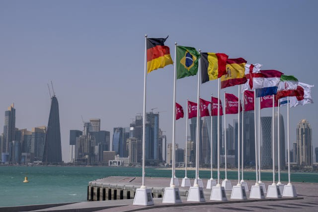 Flags of World Cup participants on the waterfront in Doha, Qatar. 
