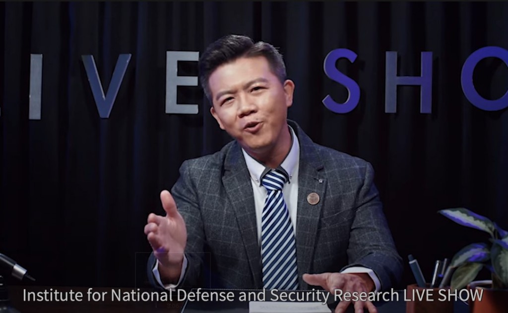 Comedian Huang Yi-hao hosts the "Institute for National Defense and Security Research LIVE SHOW." (YouTube, Institute for National Defe...