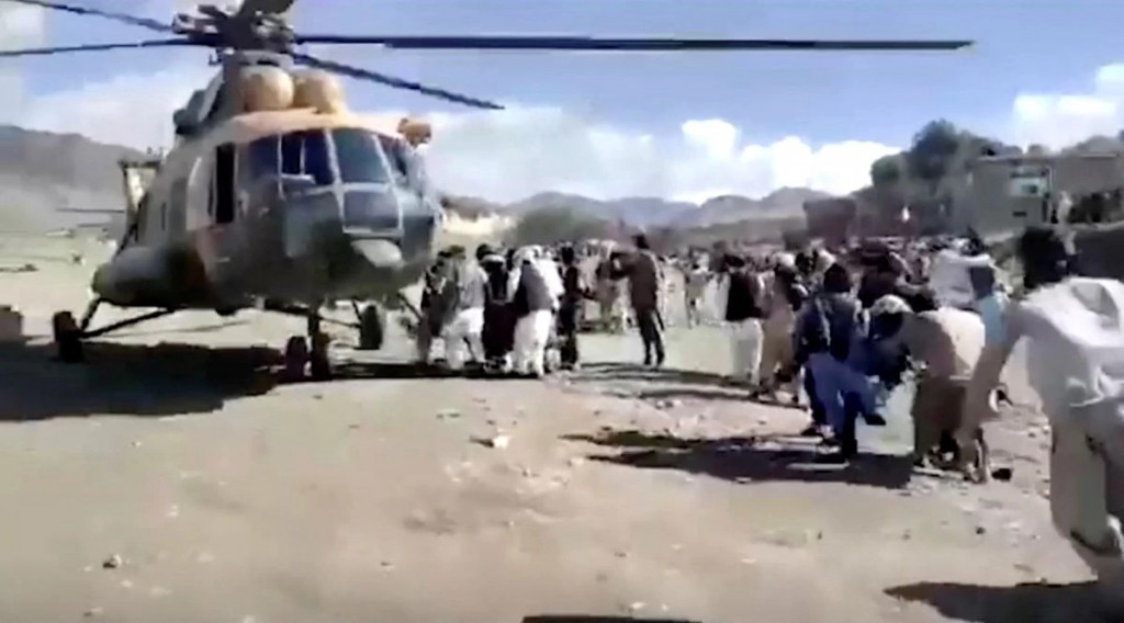  

People carry injured to a helicopter following a massive earthquake, in Paktika Province, Afghanistan, June 22, 2022, in this screen grab take...