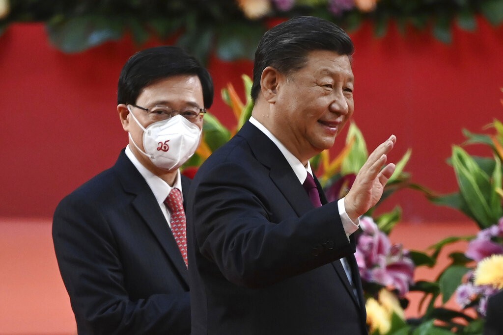 Hong Kong's new Chief Executive John Lee, left, walks with China's President Xi Jinping following Xi's speech after a ceremony to inaugura...