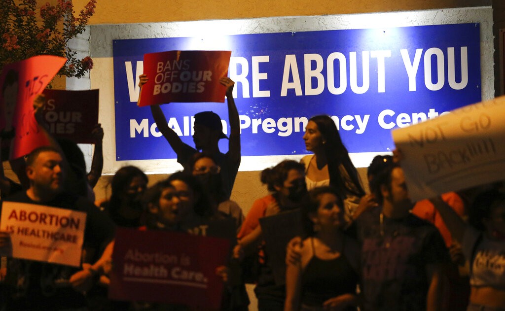 Demonstrators gather outside the Whole Women's Health clinic Friday, June 24,2022 in McAllen, Texas.
