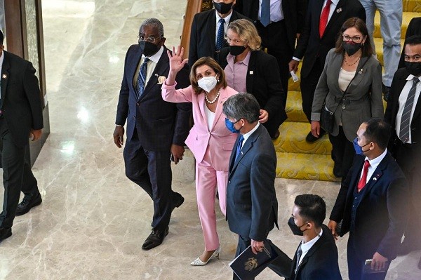  U.S. House Speaker Nancy Pelosi, center, waves to media as she tours the parliament house in Kuala Lumpur, Tuesday, Aug. 2, 2022. 
