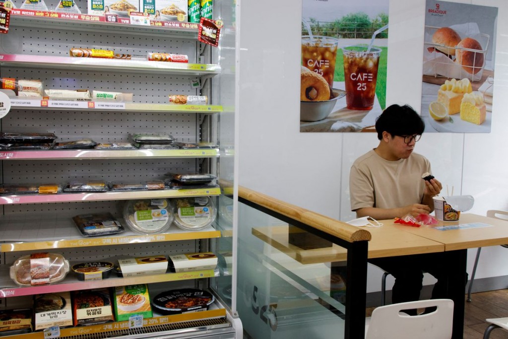FILE PHOTO: An office worker eats his lunch at a convenience store in Seoul, South Korea, June 24, 2022. REUTERS/ Heo Ran
