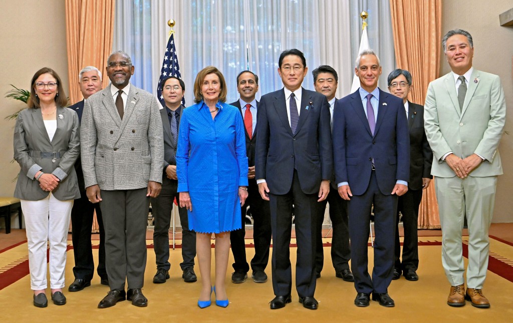 U.S. House of Representatives Speaker Nancy Pelosi and other delegates pose for a photograph with Japan's Prime Minister Fumio Kishida b...