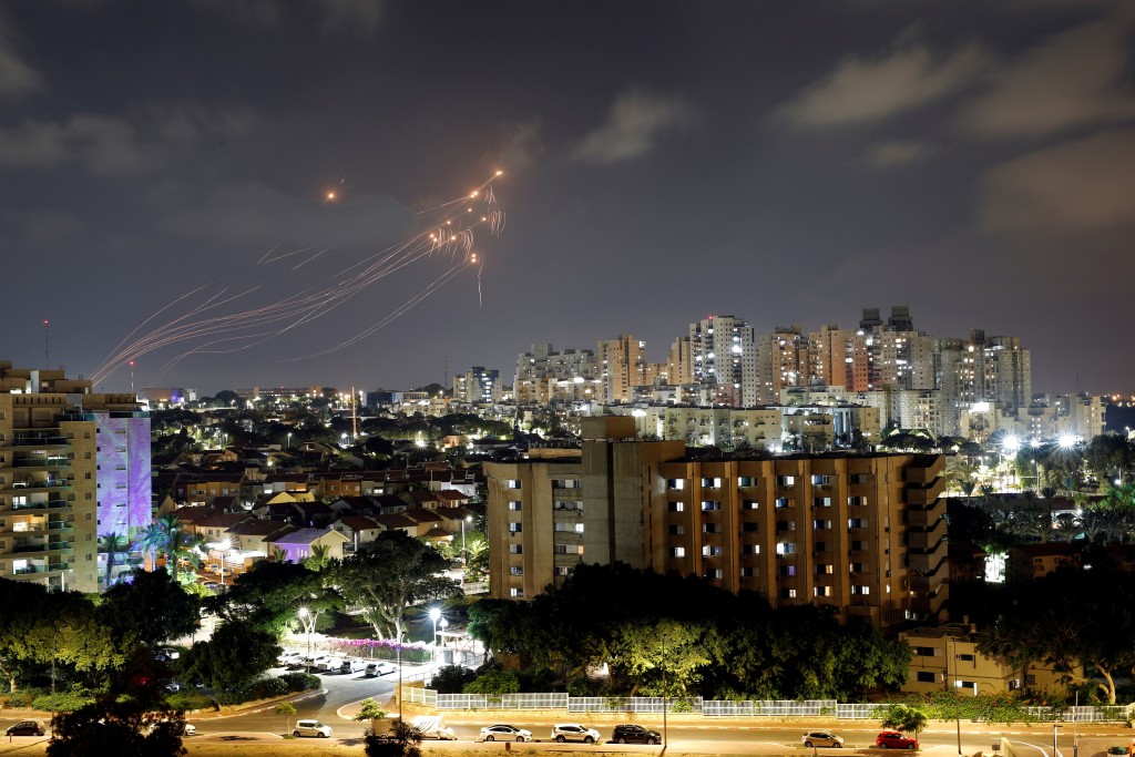 Streaks of light are seen as Israel's Iron Dome anti-missile system intercept rockets launched from the Gaza Strip towards Israel, as seen from As...