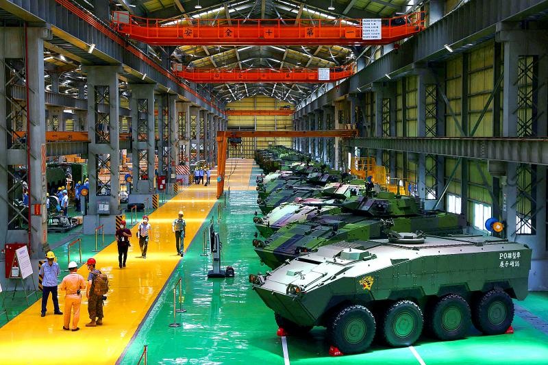 Staff members work on the production line of Taiwan military's latest armored vehicle the CM-34 Clouded Leopard in Nant...