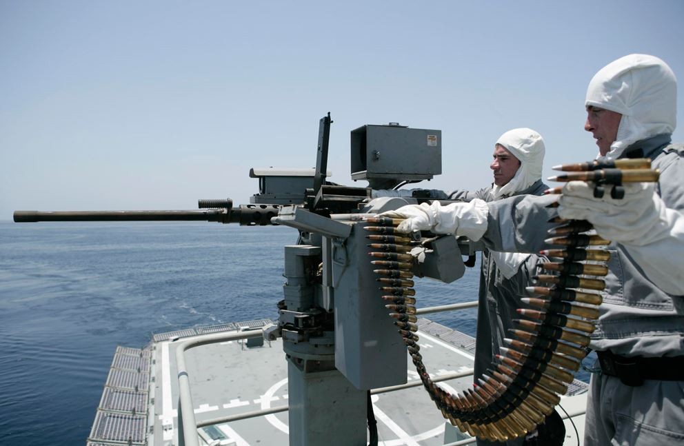 Members of the Australian navy reload a heavy machine gun after a test fire. (Australian Navy photo)
