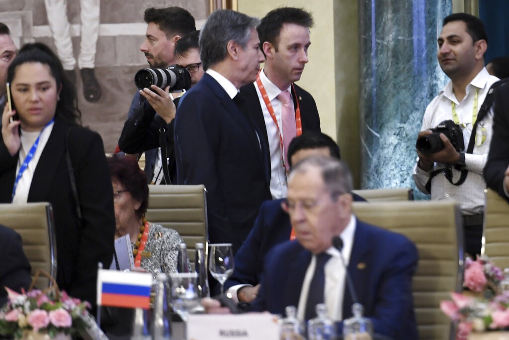 U.S. Secretary of State Antony Blinken, top center, walks past Russian Foreign Minister Sergey Lavrov during the G20 foreign ministers' meeting in...