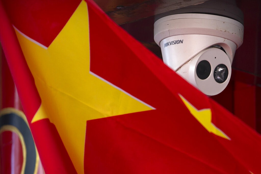 A Chinese flag hangs near a security camera outside of a shop in Beijing on Oct. 8, 2019. 

