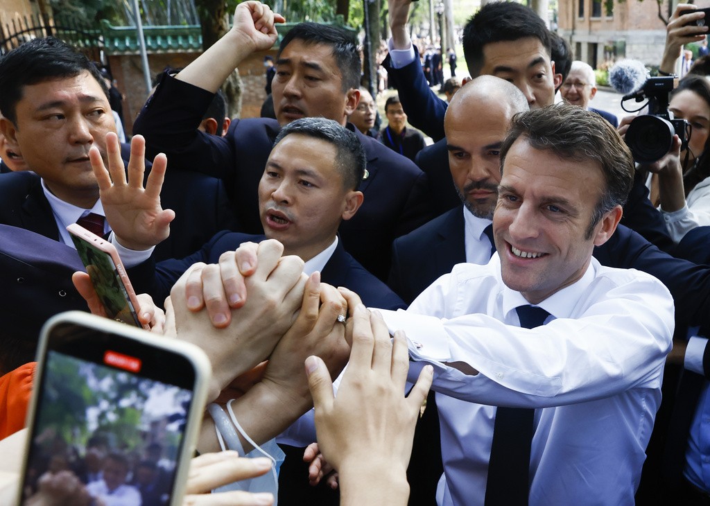 French President Emmanuel Macron, front right, arrives at Sun Yat-sen University in Guangzhou, China Friday, April 7, 2023.
