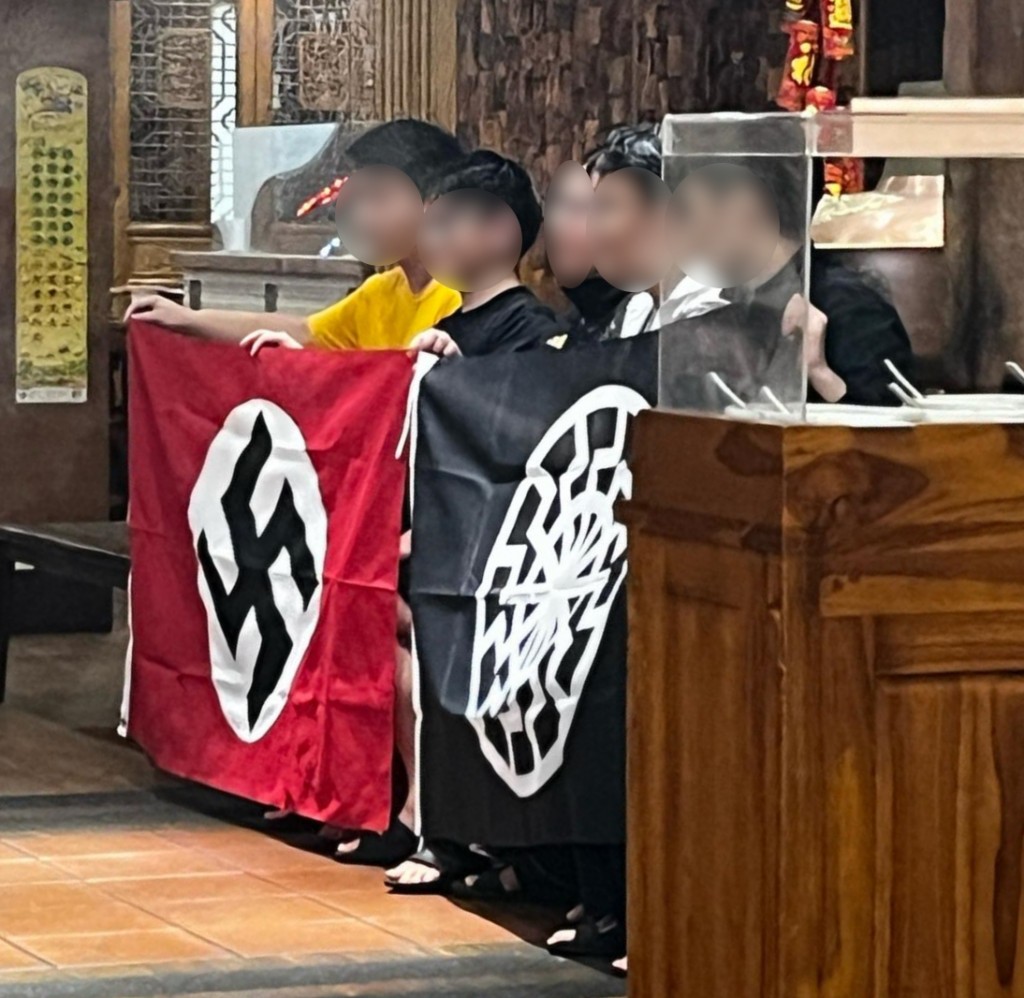 Group of men seen holding Nazi and Black Sun flags on April 20. (James Curly photo)
