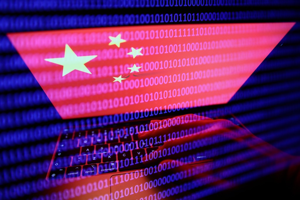 Flag of China displayed on a laptop screen and binary code displayed on a screen. (Reuters image)
