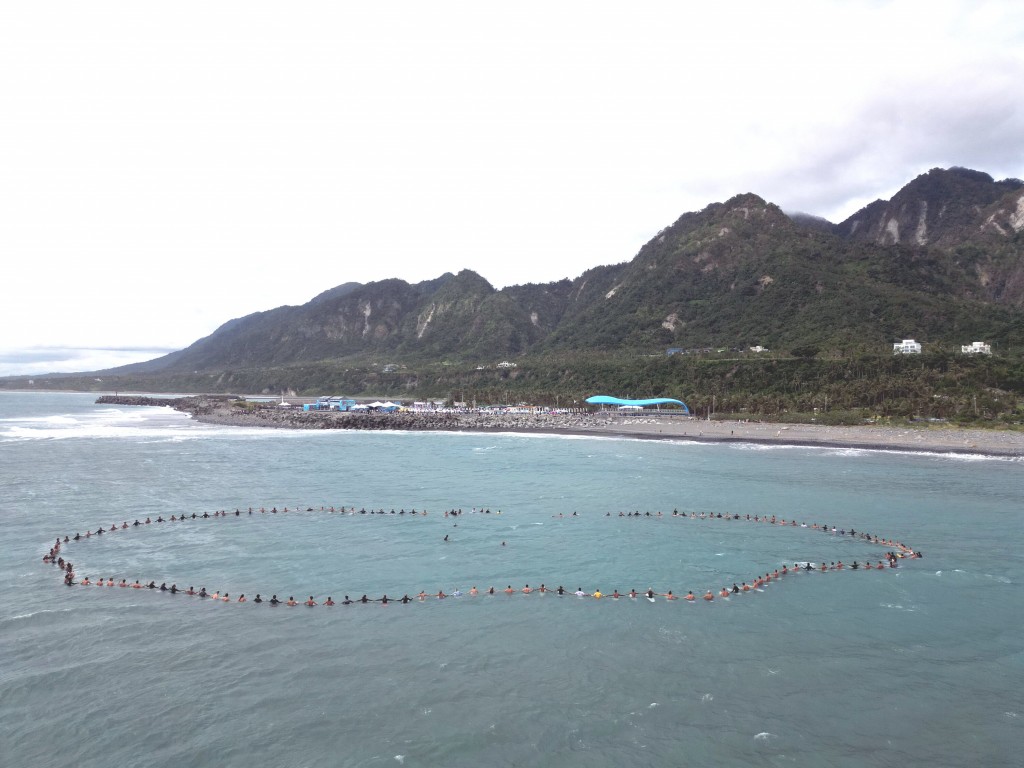 Surfers hold a "paddle out" tribiute to their Indonesian colleague Saturday after he died in a scooter crash. (CNA, Taitung County Governmen...