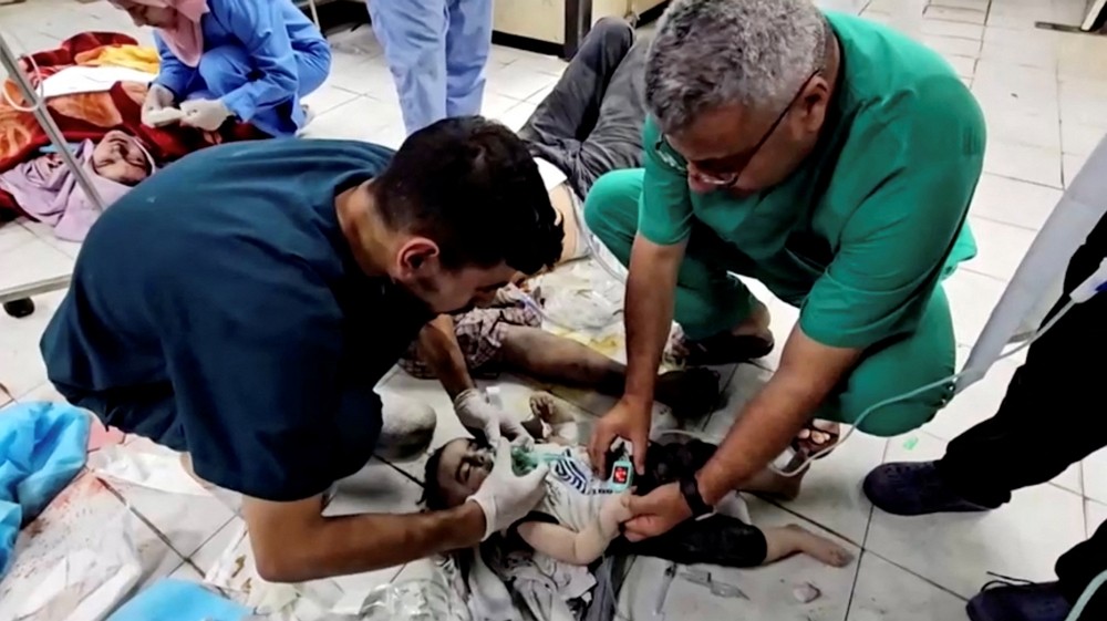 Medical workers try to rescue Palestinian baby Mosab Sobieh, who is less than a ...
