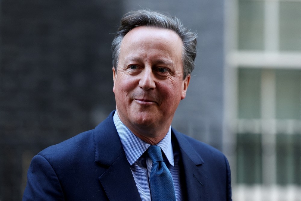 Britain's former Prime Minister and newly appointed Foreign Secretary David Cameron walks o...