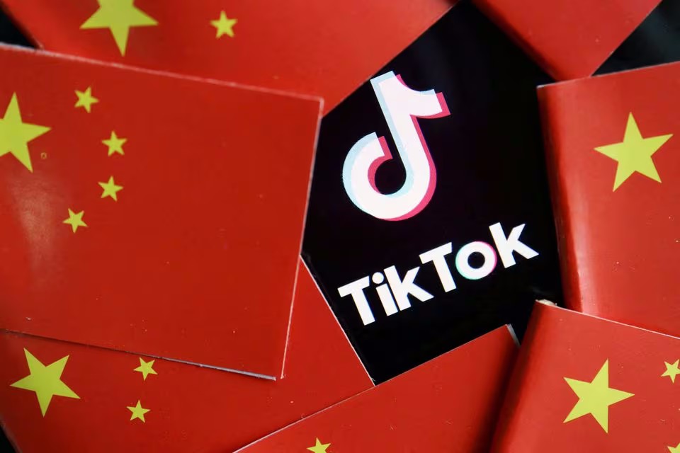 Chinese flags surround TikTok logo. (Reuters illustration)
